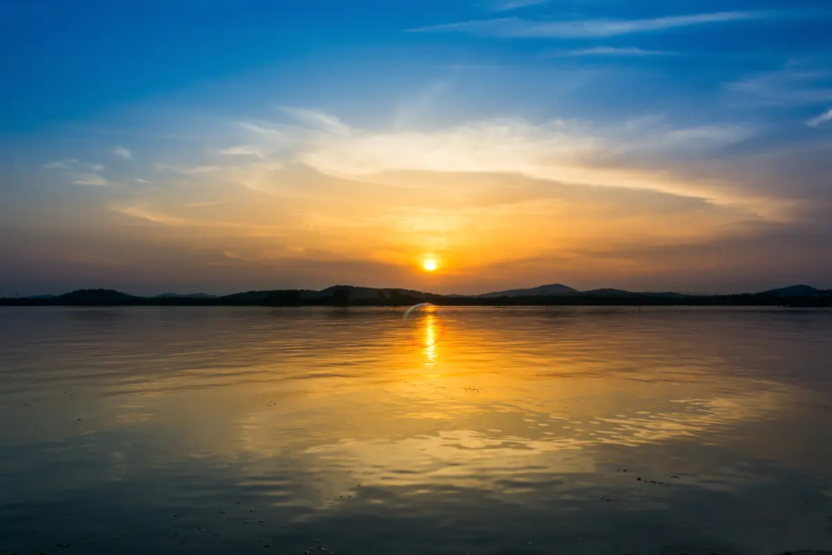 Calming sunset over a lake reflecting a peaceful therapeutic journey